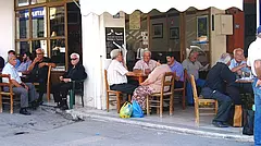 Einheimische Männer sitzen vor einem Kafenion in Kalamaki auf Kreta
